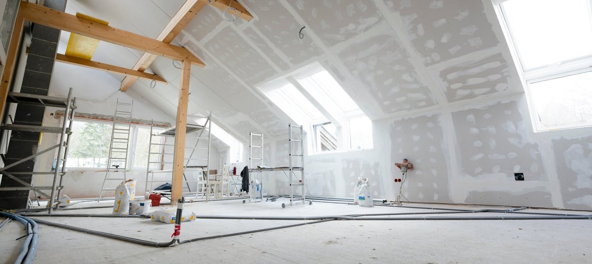 Attic under construction with drywall spackling and plastered joints — professional tape and jointing work