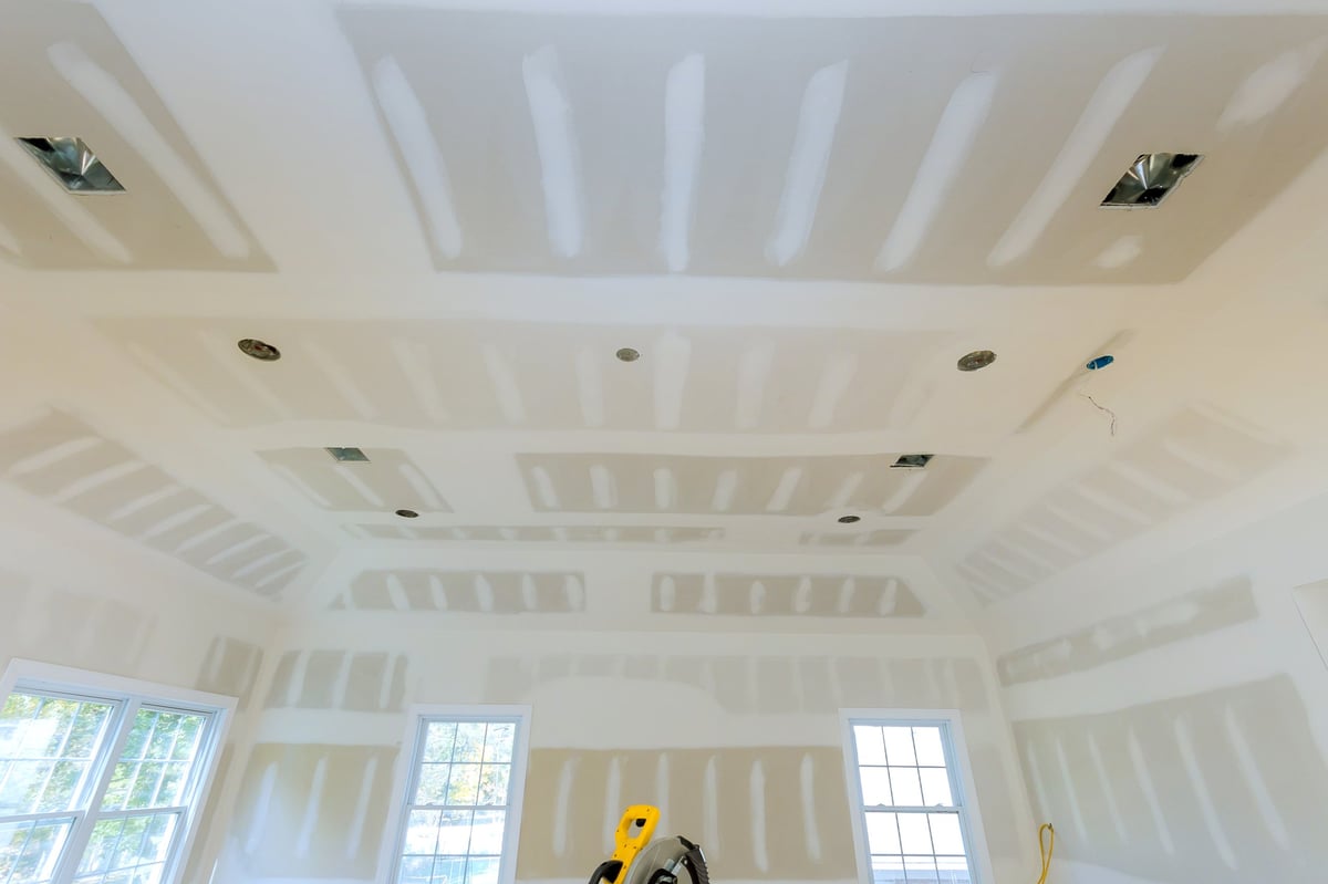 Interior room with partially finished drywall and taped joints — professional tape and jointing work